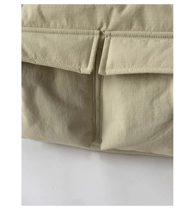 Detail of khaki ripstop fabric showing two large symmetrical pockets and precision stitching
