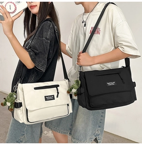 Canvas messenger bags in black and beige featuring dinosaur charms and large capacity