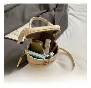 Detail view showing the spacious interior of the cream box bag with daily essentials