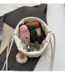 Spacious interior of white bucket bag showing large capacity with accessories