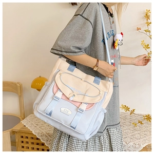 Detail of multi-pocket patchwork canvas messenger bag with adjustable buckles for students
