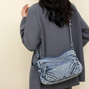 Model wearing retro snowflake wash denim tote bag with adjustable shoulder strap and zippers