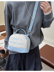 Blue and white canvas crossbody bowling bag with adjustable wide strap and text print