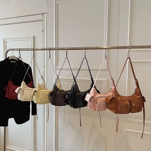 Detailed view of glossy multi-pocket underarm bags in seven stylish vintage colors