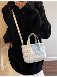 Knitted crossbody bucket bag in white and light blue gradient with leather straps