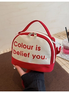 Chic two-tone canvas bowling bag in cream and red with letter print and dual zippers