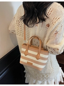 Striped knit bucket bag with faux leather handles and detachable crossbody strap