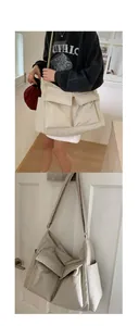 Detailed view of cream large capacity canvas bag with front pockets and wide strap
