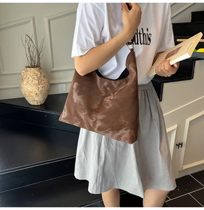 Detail of brown marble-textured PU leather hobo bag with elegant metal ring buckle