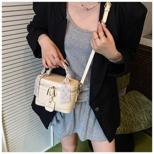 Détail du sac boîte crème avec poignée en foulard de soie et bandoulière réglable
