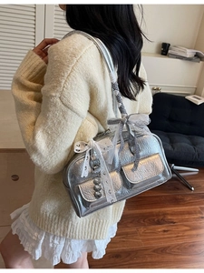 Chic silver metallic pleated shoulder bag with decorative bows and heart charm detail