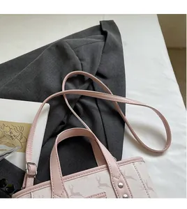 Detail of adjustable long shoulder strap on a pink deer print bucket bag for women