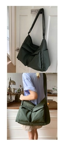 Detail of dark green large canvas messenger bag with flap pockets and wide shoulder strap
