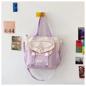 Detail of lavender and cream canvas tote bag showing buckles and adjustable strap