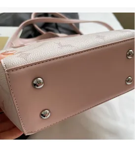 Macro shot of bottom metal studs and embossed leather texture on women bucket bag