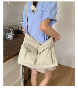Canvas messenger bag with two utility front pockets and wide adjustable strap