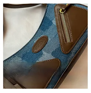 Macro view of denim patchwork textures and brown leather trim with youber logo