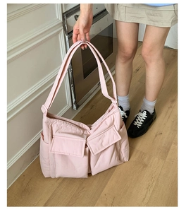 Detail of pink quilted tote bag with multi-pockets and lightweight nylon fabric finish