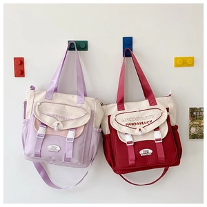 Detail view of large canvas tote bags with contrast colors and adjustable buckles