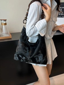 Modern black glossy leather hobo shoulder bag featuring unique wooden beaded strap