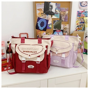 Detail view of canvas crossbody bags with buckle closures and multiple storage pockets