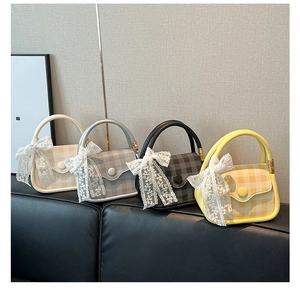 Detail view of plaid mini handbags in four colors featuring lace bow handles and metal buckles