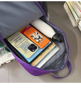 Detailed internal view showing large capacity and multi-pocket storage of the purple backpack