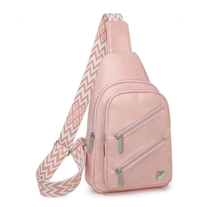 Detail of pink faux leather sling bag featuring three front zippers and a woven strap