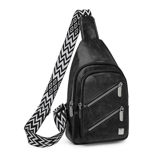 Detail of black PU leather chest bag with decorative geometric patterned wide strap