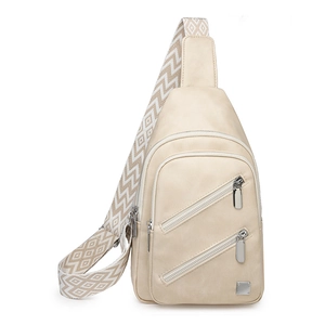 Detail of beige crossbody chest bag with adjustable jacquard strap and silver zippers
