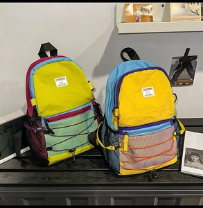 Detail of color-block backpack with functional side mesh pocket and elastic drawstring