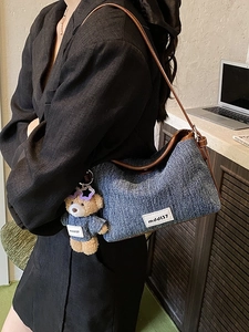 Denim bucket shoulder bag with leather trim and a cute plush bear pendant accessory