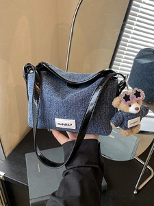 Fashionable blue denim bucket bag with mddl37 patch and cute bear keychain charm