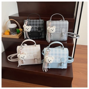 Collection of plaid patterned crossbody bags in four colors with bear charm and tassel