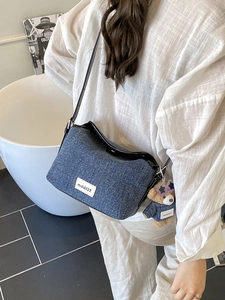 Blue denim crossbody bucket bag featuring mdd137 label and cute teddy bear pendant