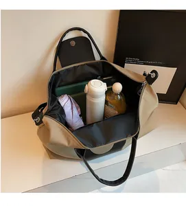 Top view of spacious khaki travel tote interior filled with tech and essentials