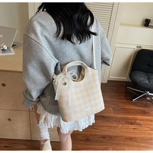 Plaid tote bag with lace bow and pearl chain shown in a casual lifestyle setting
