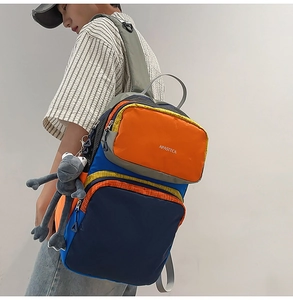Detail view of large capacity multi-pocket travel backpack with blue and orange panels