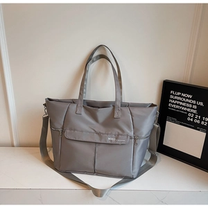 Détail du grand sac cabas gris en nylon avec logo NOCO et bandoulière amovible