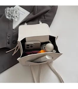 Detail view of the large capacity interior of the plaid backpack with daily essentials