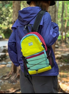 Close-up of colorful outdoor backpack with elastic storage ropes and mesh pockets