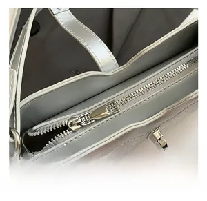 Detail shot of the premium silver metal zipper and hardware on a vintage baguette bag