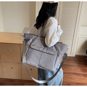 Détail du grand sac cabas gris en nylon imperméable avec plusieurs poches zippées