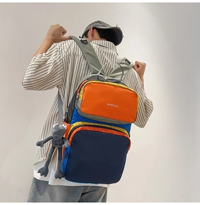 Outdoor backpack with color-blocking design and cute plush frog keychain decoration