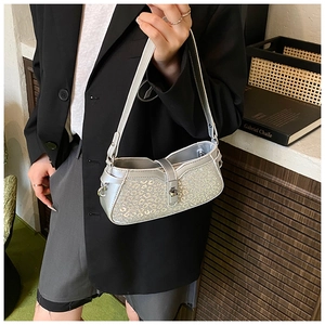 Close-up of silver leopard print shoulder bag with metallic glitter texture and lock