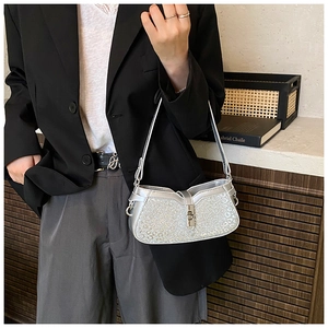 Detail of silver sequin hobo bag with leopard pattern and metal twist lock closure