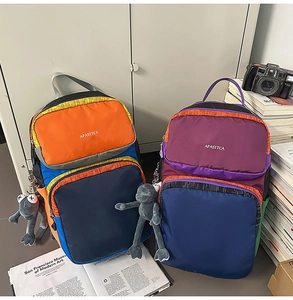 Close-up of colorful multi-pocket backpacks with creative charms and student accessories