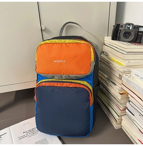 Close-up of multicolor nylon backpack with zipper pockets and APASTTCA logo print