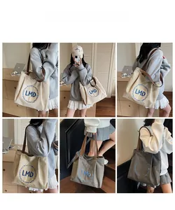Detailed views of canvas tote bag with embroidered logo and contrast leather straps