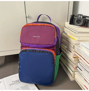 Macro shot of multi-color nylon backpack with side pockets in a campus lifestyle scene